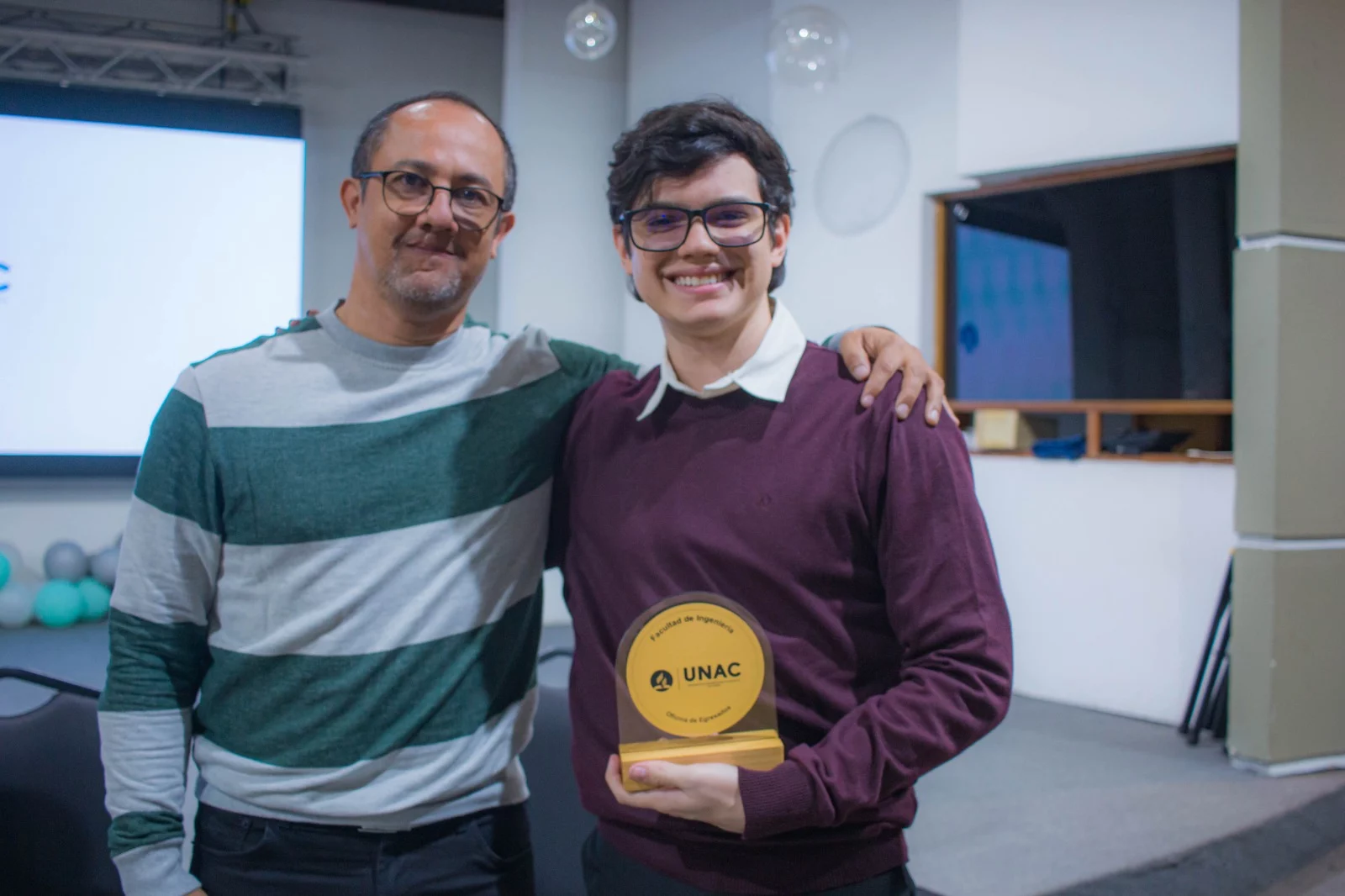 LuIs Álvares junto al decano de la facultad de ingenieria recibiendo su distincion como egresado destacado en el evento del encuentro de egresados de ingenieria UNAC